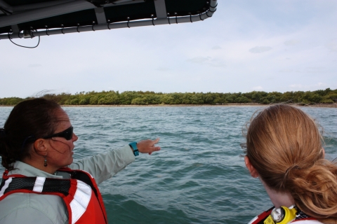 Suzy Pappas (Coastal Cleanup Corporation) and Nancy Wallace (Marine Debris Program Director) searching for marine debris on Elliot Key, Florida while on a boat.