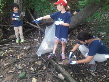 Kids cleaning up a shoreline.