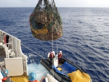 Large net being pulled onto a boat. 