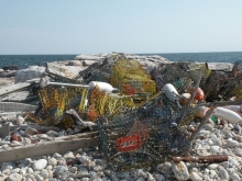 A pile of fishing gear laying on the beach.
