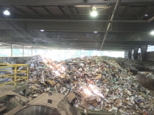 A large heap of trash at a recycling center.