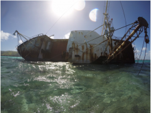 An abandoned ship has been tipped on its side.