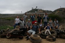 People sitting on a pile of tires.