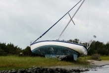 A sailboat lays on its side in the Rachel Carson Reserve.