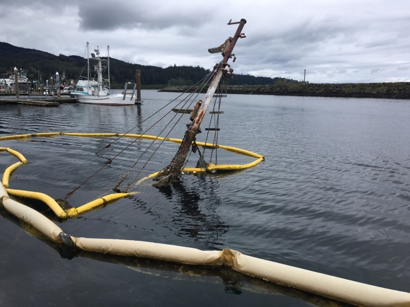 The mast of a sunken vessel protrudes out of the water at the Makah Marina in Neah Bay. 