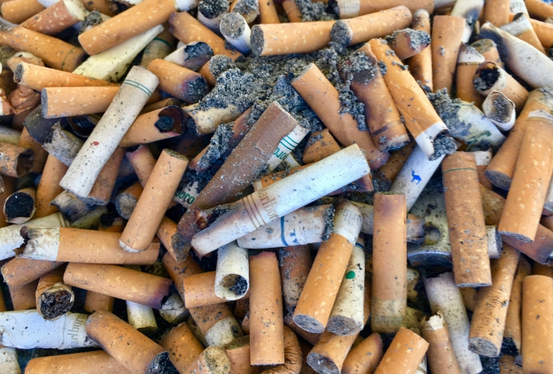 Cigarette butts mixed in with sand.