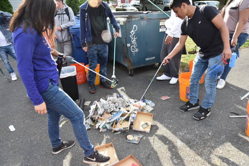 Students collect and sort trash. 