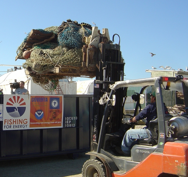 Nets being loaded into a Fishing for Energy bin. 
