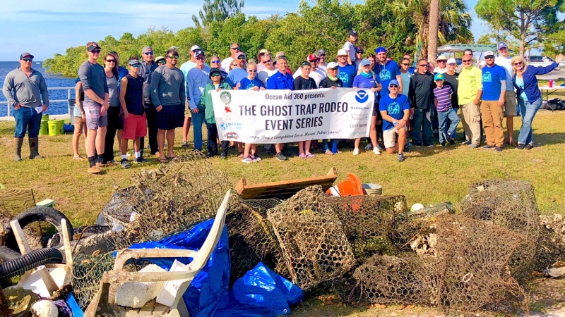 Group holding a "Ghost Trap Rodeo" banner. 