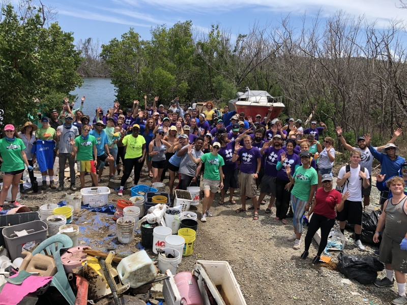 Cleanup volunteers pose next to their collected debris. 