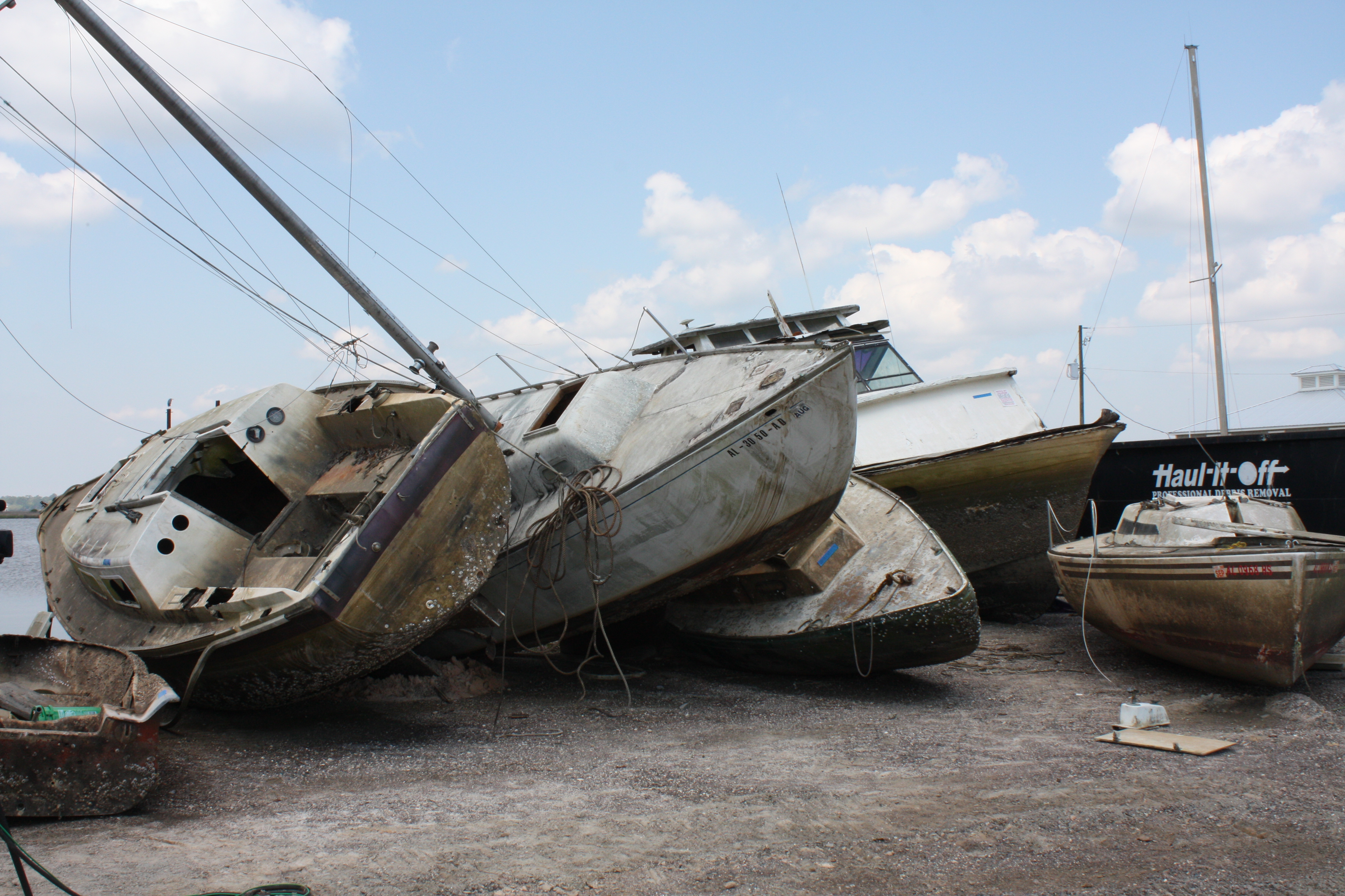Damaged vessels piled up in a marina.
