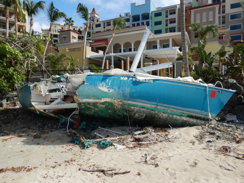 A boat is tipped on its side on a beach located on St. Thomas in the U.S. Virgin Islands.