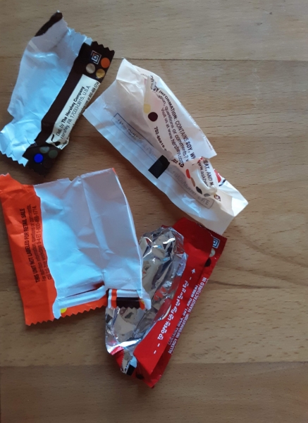 A pile of opened candy wrappers.