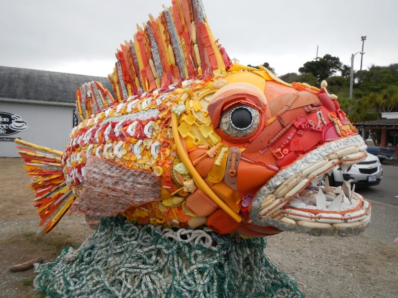A large fish sculpture created with marine debris.