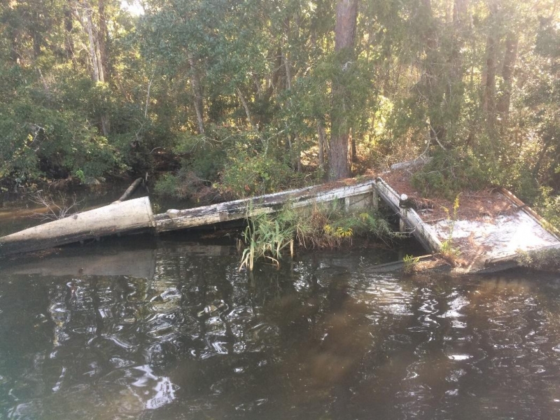 A derelict vessel in a river. 