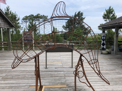 A metal frame sculpture of a dolphin.