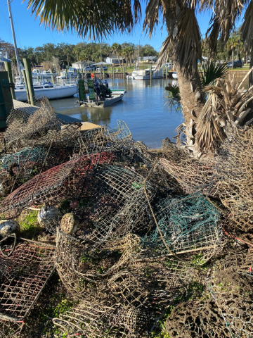 Old crab traps piled up near the shore.