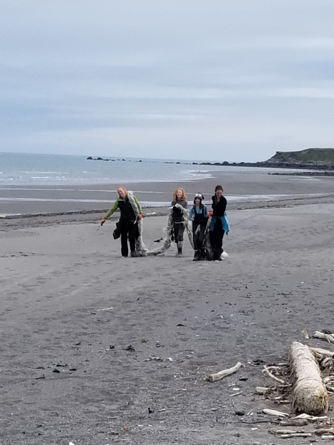 Volunteers clear large rope off beach.