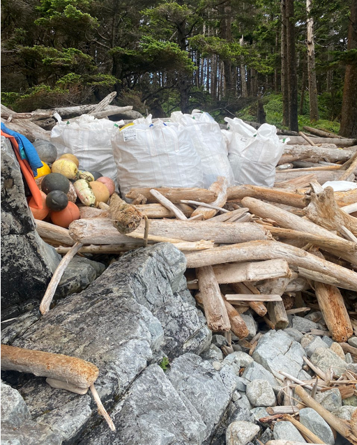 Debris collected into super sacks on an Alaskan shoreline for transport.