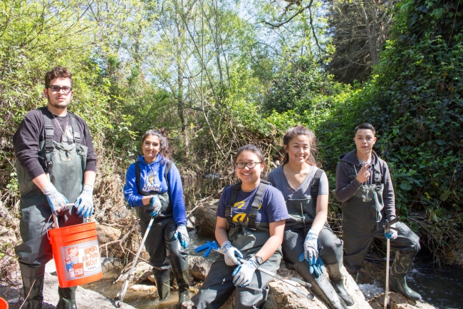 A group of students with gear for a cleanup.