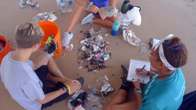 Students sorting through a small pile of collected debris.
