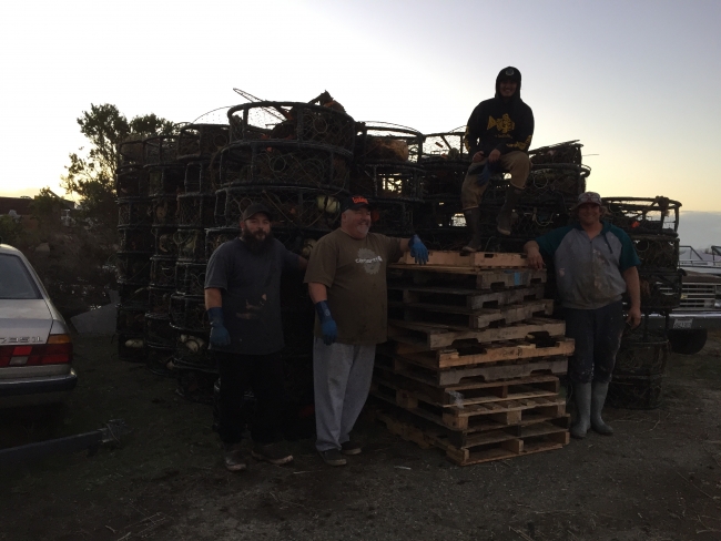 Fishermen Andy Guiliano, Robby Maharry, and crew in front of derelict crab pots collected through this project.