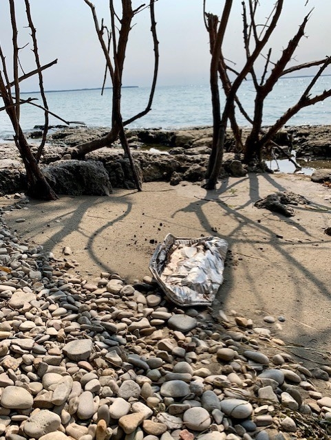 Food packaging litter on a shoreline. 