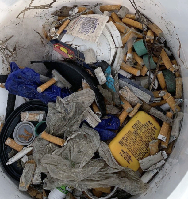 A bucket of discarded cigarette butts.