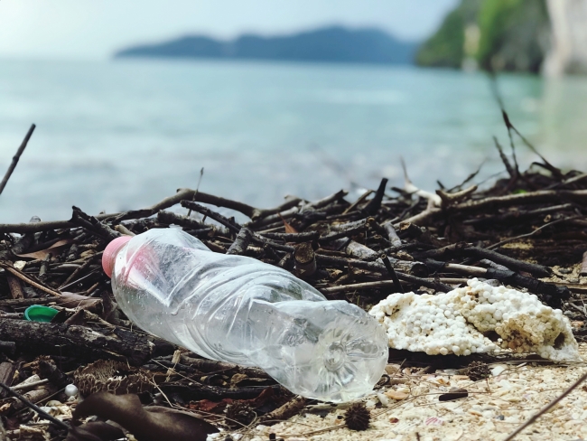 A used plastic bottle on a beach. 