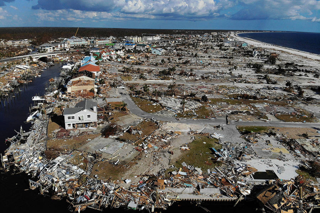 Aerial view of flattened houses and debris left behind after a major hurricane.