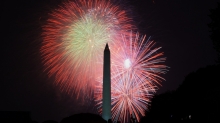 Fireworks light up the night sky behind the Washington Monument.