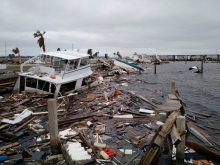 A half sunken boat is surrounded by floating wood debris caused by Hurricane Michael in Panama City Florida. 
