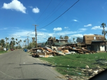 Building debris next to a damaged home.