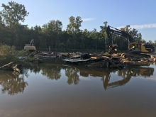 Heavy machinery on the banks of a river. 