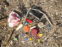Bottle caps, straws, cigarette butts, and other debris removed from the shoreline of Lake Erie in Ohio.