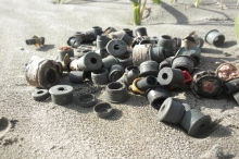A pile of plastic plugs on a beach.