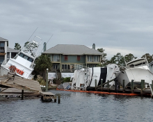 Vessels and a dock left damaged after a hurricane.