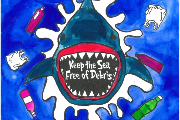 A child's drawing of a shark coming out of the water surrounded in marine debris and with the words "Keep the sea free of debris."