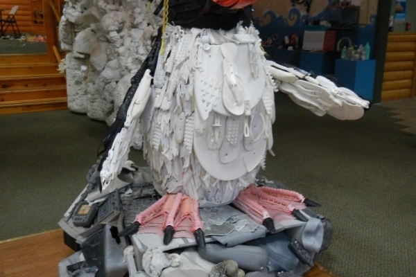 A puffin sculpture made of marine debris including tire pieces, brush bristles and rope.